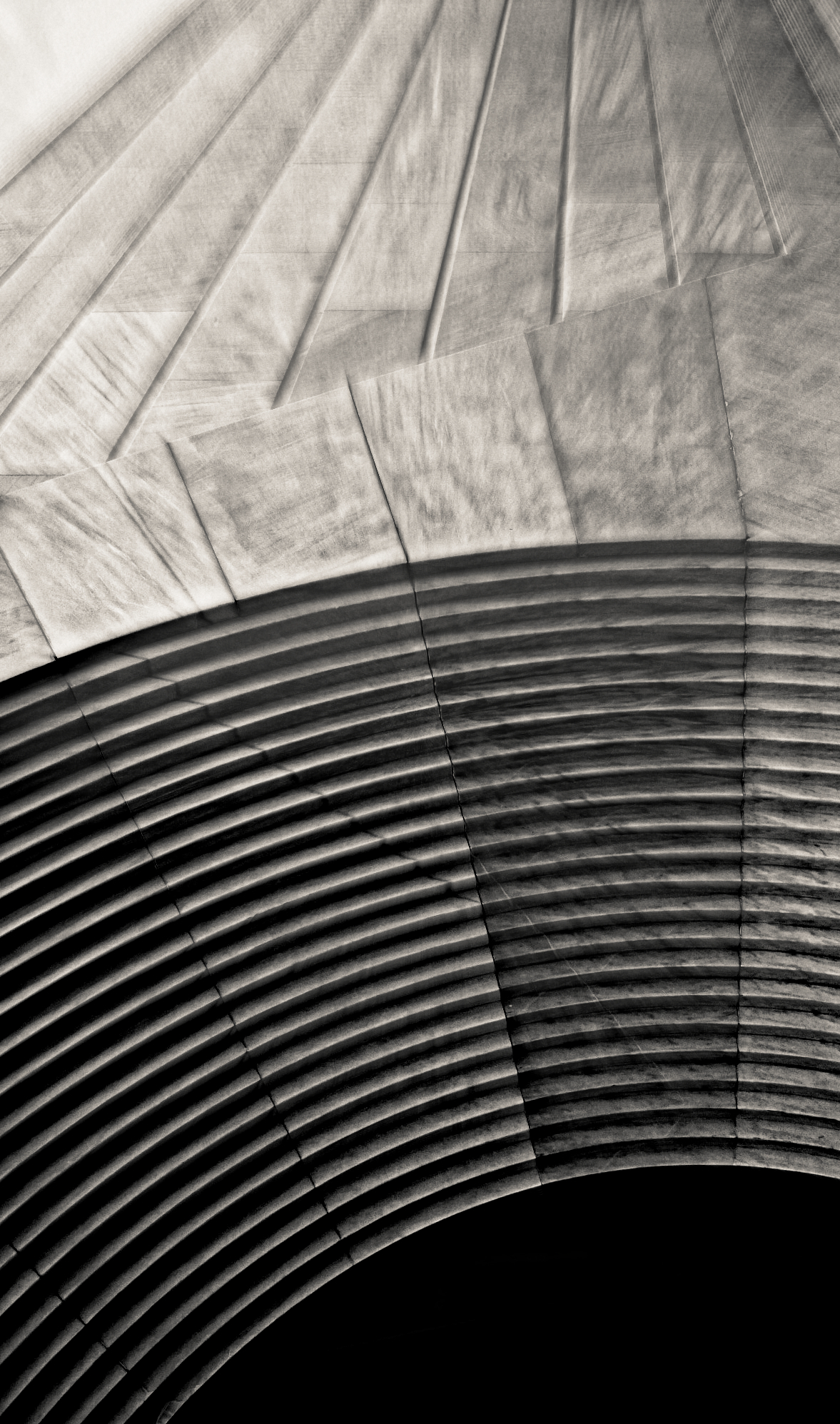 Abstract architectural curves and radiating lines in stone