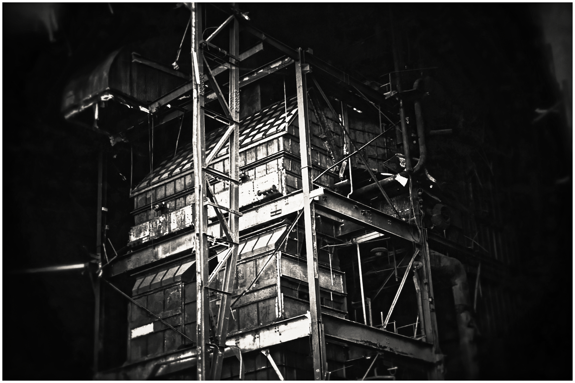 Dark industrial metal structure with scaffolding and platforms